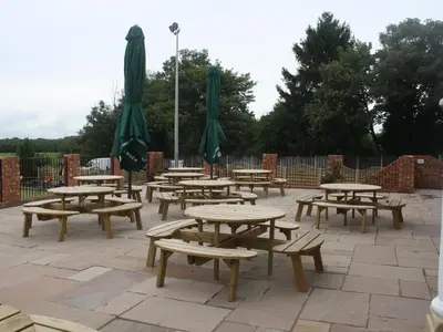 a group of picnic tables and umbrellas on a patio at The Corbet Arms in Shrewsbury