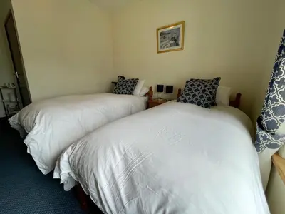 a room with two beds in a room at Plough and Harrow in Brecon