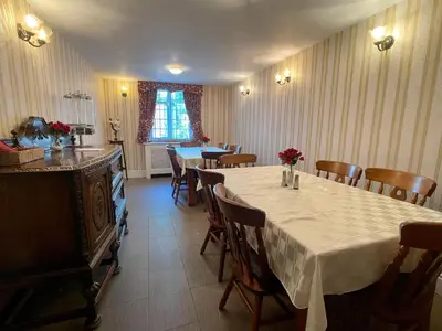 a dining room with a long table and chairs at Plough and Harrow in Brecon