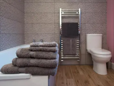 a bathroom with a pile of towels on a tub at Chapel House Cottage in Builth Wells