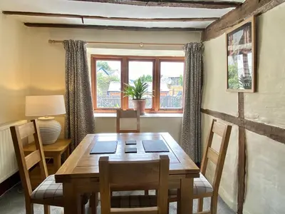 a dining room with a wooden table and chairs at Number 22, Castle Street in Hay-on-Wye