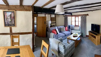 a living room with a couch and a tv at Number 22, Castle Street in Hay-on-Wye