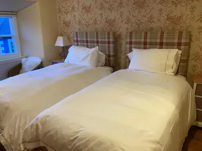 two beds sitting next to each other in a bedroom at The Drovers Bed and Breakfast in Llandovery