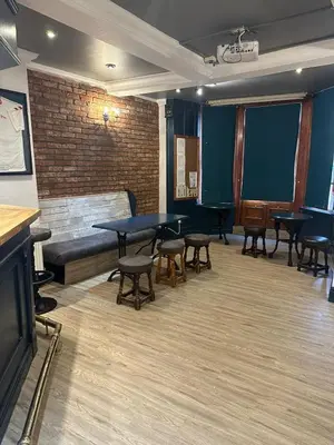 a waiting room with tables and chairs and a couch at Plas Coch Hotel Ltd in Bala