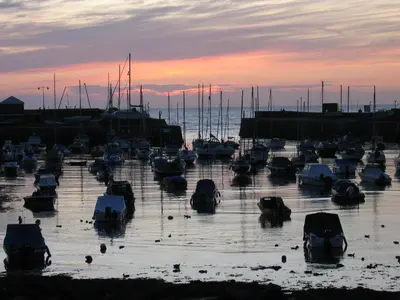 a group of boats in a marina at sunset at Harbourmaster Hotel in Aberaeron