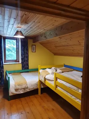 two bunk beds in a room with a wooden ceiling at Welshhomestead in Tregaron