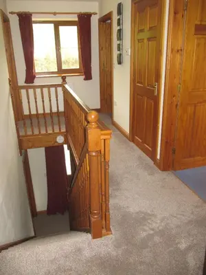 a wooden staircase in a room with a window at Nant-Y-Glyn in Llandrindod Wells