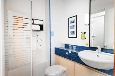 a bathroom with a sink and a toilet and a shower at Holiday Inn Express Shrewsbury by IHG in Shrewsbury