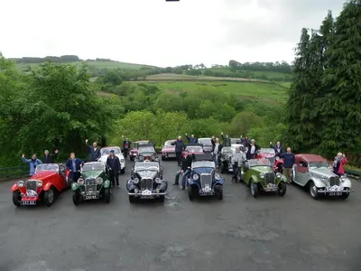 a group of antique cars parked in a parking lot at Llanerchindda Farm Guest House in Cynghordy