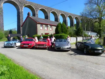 a group of people standing in front of parked cars at Llanerchindda Farm Guest House in Cynghordy