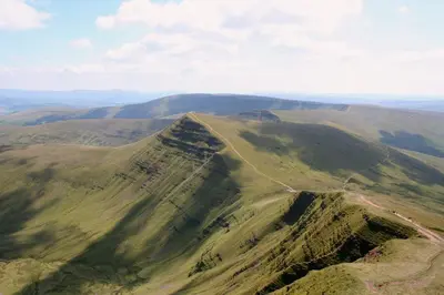 an aerial view of a mountain with a road on it at Llanerchindda Farm Guest House in Cynghordy