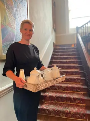 a man holding a tray of pottery at Peterstone Court Country House Restaurant & Spa in Brecon