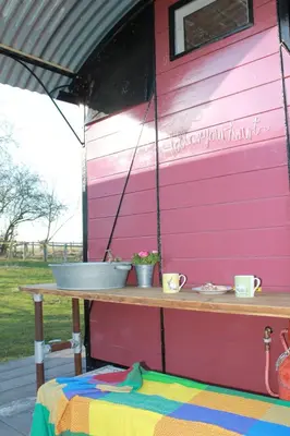a pink house with a table in front of it at Off the Rails in Oswestry