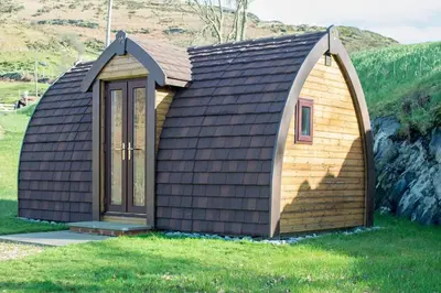 a small house with a gambrel roof at Bwlcheinion Sea View Glamping in Machynlleth