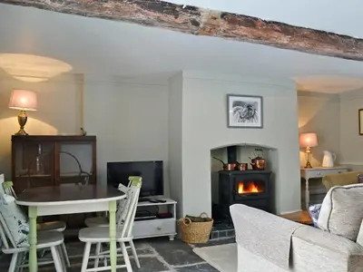 a living room with a table and a fireplace at The Cider Barn in Presteigne