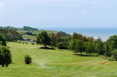 a view of a golf course with trees and grass at Penrhos Park in Aberystwyth