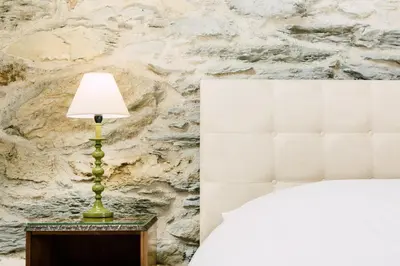 a lamp sitting on a table next to a bed at Glyn Mawr Barn in Bala