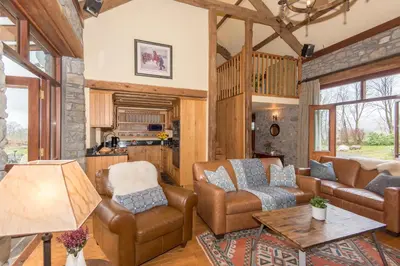 a living room with a couch and chairs and a table at Cae'r Beili in Llandovery