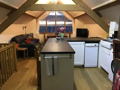 a kitchen and living room with a counter in a room at Beautiful Wales in Barmouth