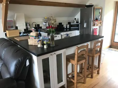a kitchen with a large black counter top in a room at Beautiful Wales in Barmouth
