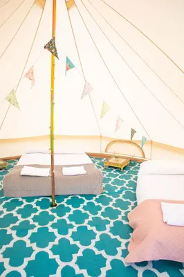 a bedroom with two beds in a tent at Glamping at Hay Festival in Hay-on-Wye
