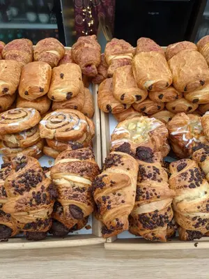 a bunch of pastries on display in a bakery at Glamping at Hay Festival in Hay-on-Wye