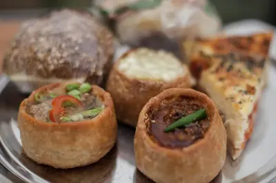 a plate of food with a bunch of pastries at Glamping at Hay Festival in Hay-on-Wye