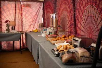a table with two long tables with food on it at Glamping at Hay Festival in Hay-on-Wye
