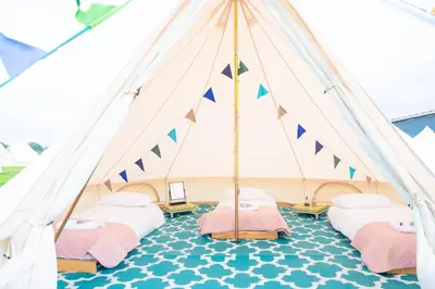 a marquee with four beds in a tent at Glamping at Hay Festival in Hay-on-Wye