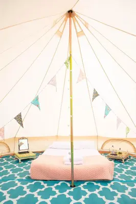 a bedroom with a bed in a tent at Glamping at Hay Festival in Hay-on-Wye