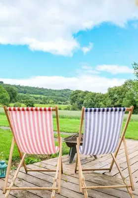 two chairs sitting on top of a wooden deck at Wye Glamping in Velindre