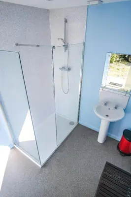 a bathroom with a shower and a sink at Wye Glamping in Velindre