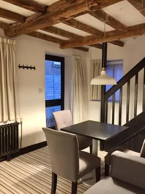 a dining room with a black table and chairs at Greenbank Lodge LLANGOLLEN in Llangollen