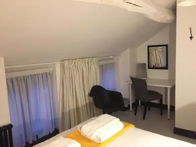 a bedroom with a bed and a desk and a table at Greenbank Lodge LLANGOLLEN in Llangollen