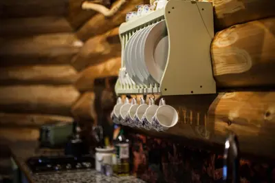 a row of coffee cups hanging on a wall at Coed y Marchog Woodland Retreat in Hereford
