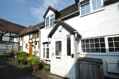 a white house with a white door at Abbey Cottage in Shrewsbury