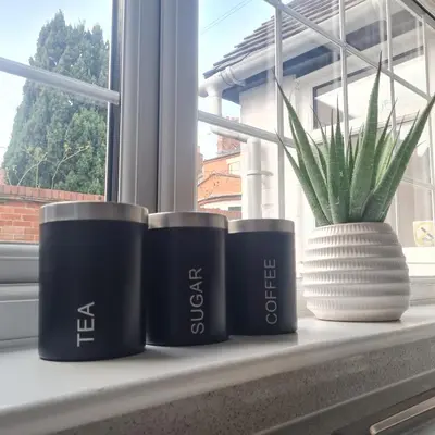 four pots sitting on a window sill next to a plant at Abbey Cottage in Shrewsbury