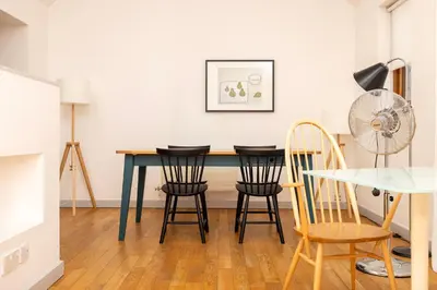 a dining room table with chairs and a fan at Lion & Pheasant Hotel in Shrewsbury