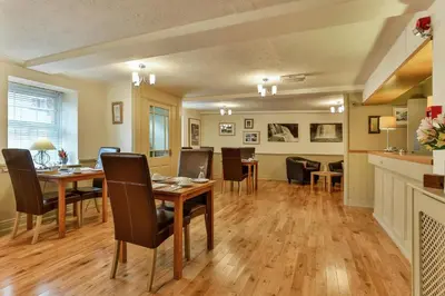 a dining room with a table and chairs at The Coach House Brecon in Brecon