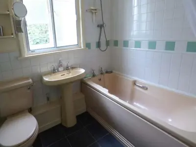 a bathroom with a sink and a toilet and a tub at Fiddlers Green in Bucknell