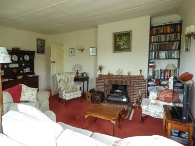 a living room with a couch and a fireplace at Fiddlers Green in Bucknell
