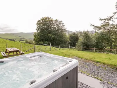 a hot tub in the middle of a field at Bryndan in Machynlleth