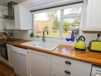 a kitchen counter with a sink and a window at Dolau Meurig in Ystrad Meurig