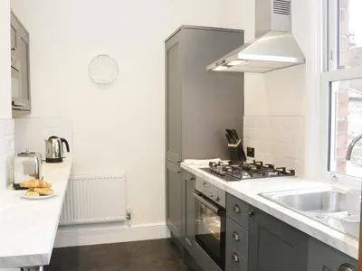 a kitchen with a sink and a stove at 7 Monkmoor Road in Shrewsbury