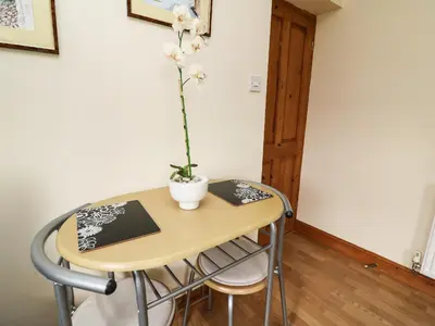 a table and chairs with a plant on it at Blaenywawr Annexe in Cross Inn