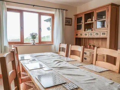 a dining room with a table and chairs and a window at Blaen Henllan in Aberedw