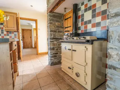 a kitchen with a sink and a stove at Blaen Henllan in Aberedw