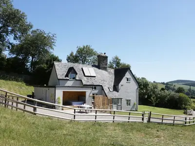 a house on a hill with a fence at Lower Hodre in Bucknell