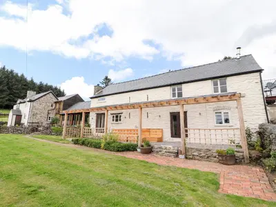 a large white house with a yard at Pant Dafydd Goch in Glyn-Ceiriog