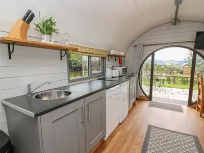an open kitchen with a sink and an archway at Woodland View in Saint Harmon